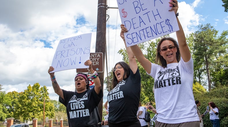 Incarcerated Lives Matter protesters, including Jenny Arellano, from left, Aubri Escalera and Dr. Christy Perez, right, call for reform of the Georgia prison system with a gathering across the street from the Governor's Mansion on Tuesday. That day, the U.S. Department of Justice released a damning report on violent conditions within the state's prison system. (Jenni Girtman for The Atlanta Journal-Constitution)