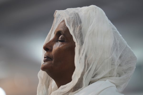 A congregant of the Re'ese Adbarat Debre Selam Kidist Mariam Church, an Ethiopian Orthodox Tewahedo church, stands during a service in Washington, D.C., Saturday, April 5, 2025. (AP Photo/Jessie Wardarski)