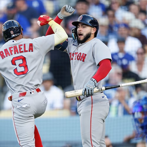 Boston Red Sox's Ceddanne Rafaela (3), left, is greeted by Boston Red Sox's Wilyer Abreu (52) after hitting a solo home run during the first inning of a baseball game against the Los Angeles Dodgers, Saturday, Aug. 1, 2026, in Los Angeles. (AP Photo/Caroline Brehman)