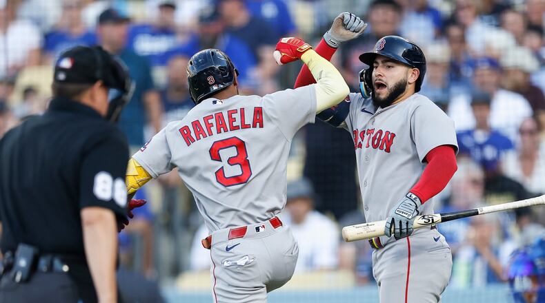 Boston Red Sox's Ceddanne Rafaela (3), left, is greeted by Boston Red Sox's Wilyer Abreu (52) after hitting a solo home run during the first inning of a baseball game against the Los Angeles Dodgers, Saturday, Aug. 1, 2026, in Los Angeles. (AP Photo/Caroline Brehman)
