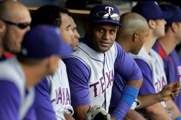 FILE - Texas Rangers' Sammy Sosa sits on the bench against the Detroit Tigers in the ninth inning of the first game of a Major League Baseball doubleheader in Detroit, Sept. 11, 2007. (AP Photo/Paul Sancya, File)
