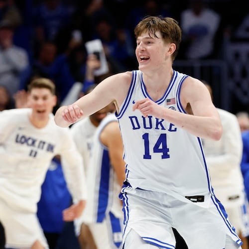 Duke guard Nikolas Khamenia (14) celebrates as Duke defeats Virginia in an NCAA college basketball game in the championship of the Atlantic Coast Conference tournament in Charlotte, N.C., Saturday, March 14, 2026. (AP Photo/Nell Redmond)