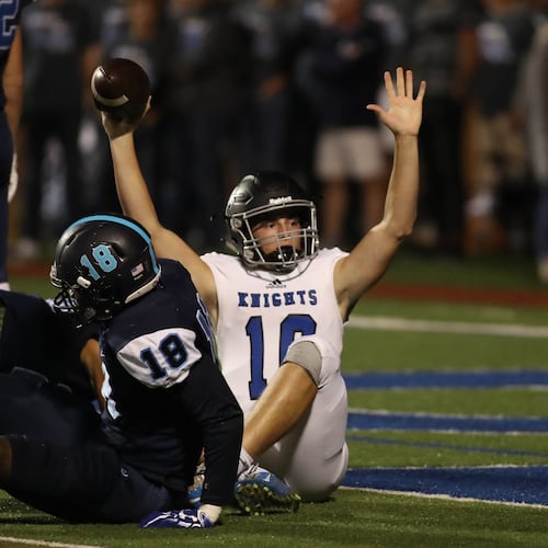 Centennial quarterback Max Brosmer (center) — pictured celebrating a rushing touchdown against Pope in October 2017 — will make his first NFL start today for the Vikings. Minnesota takes on the Seattle Seahawks, who are coached by another Centennial graduate, Mike Macdonald. (Jason Getz/AJC 2017)