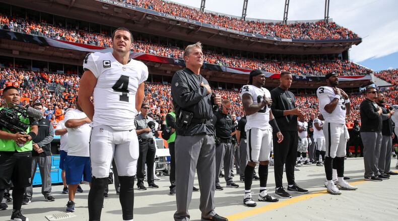 Oakland Raiders personnel, including Derek Carr (4) and head coach Jack Del Rio, stand during the national anthem before a game against the Denver Broncos at Sports Authority Field at Mile High on October 1, 2017 in Denver, Colorado. (Photo by Matthew Stockman/Getty Images)