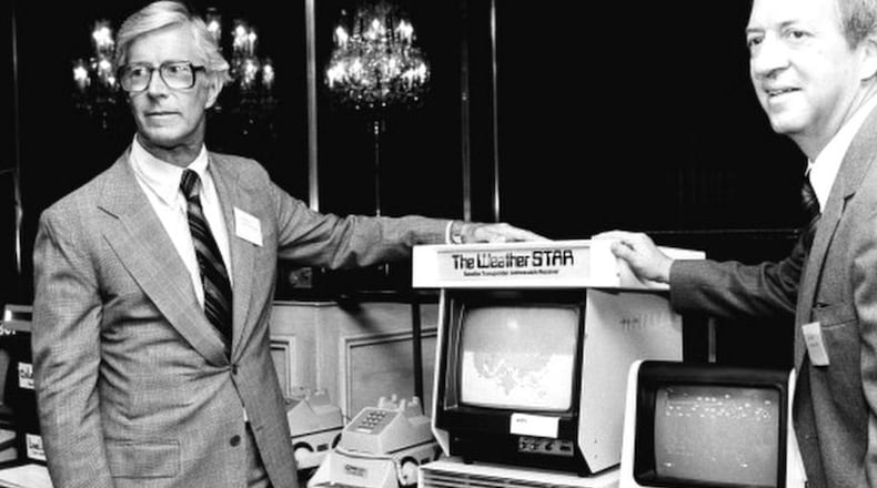 CORRECTS THAT COLEMAN IS AT RIGHT, NOT LEFT - In this July 30, 1981 photo, John Coleman, weather channel founder, right, and Frank Batten, publisher of the Norfolk, Va., Virginian-Pilot and Ledger-Star, and chairman and chief executive of Landmark Communications, Inc., are seen during a news conference in New York. John Coleman, the founder of The Weather Channel and longtime KUSI weatherman, died Saturdaty night, Jan. 20, 2018, at home in Las Vegas, said his wife Linda Coleman. He was 83. (AP Photo/Marty Lederhandler, File)