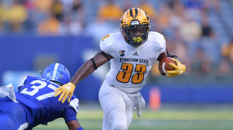 August 30, 2018 Atlanta - Kennesaw State running back Darnell Holland (33) eludes a tackle by Georgia State linebacker Victor Heyward (37) in the first half during the 2018 season opening game against the Kennesaw State at Georgia State Stadium on Thursday, August 30, 2018. HYOSUB SHIN / HSHIN@AJC.COM