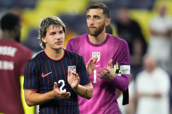 United States defender John Tolkin (2) and goalkeeper Matt Turner (1) applaud the fans after the team's loss in an international friendly soccer match against the Switzerland, Tuesday, June 10, 2025, in Nashville, Tenn. (AP Photo/George Walker IV)