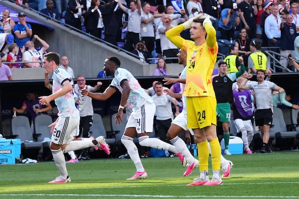 U.S. goalkeeper Matt Freese (in yellow) reacts after Belgium scores their third goal during the World Cup round of 16 soccer match in Seattle on Monday. (Ted S. Warren/AP)