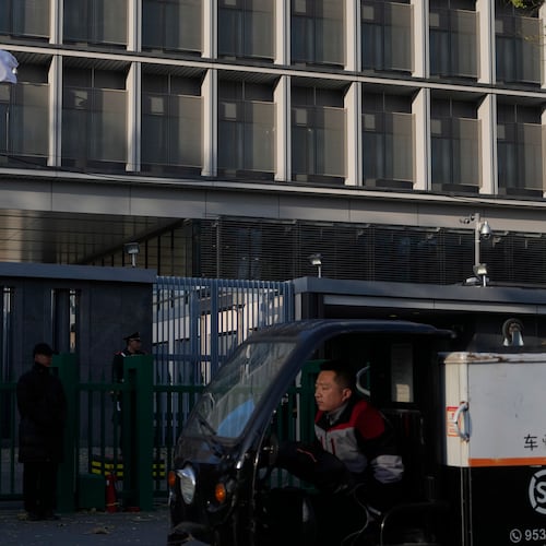 A delivery man drives past the Japanese Embassy in Beijing on Nov. 24, 2025. (AP Photo/Ng Han Guan)