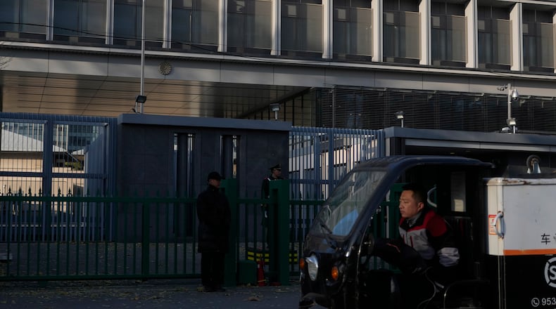 A delivery man drives past the Japanese Embassy in Beijing on Nov. 24, 2025. (AP Photo/Ng Han Guan)