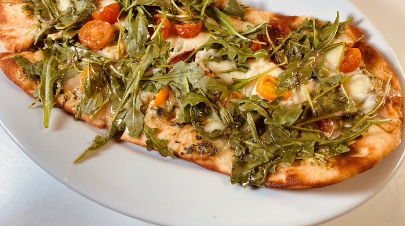 The Garden flatbread is topped with creamy spinach and artichoke sauce, cherry tomatoes, melted mozzarella and fresh arugula at Taffer’s Tavern.
Bob Townsend for the Atlanta Journal-Constitution.