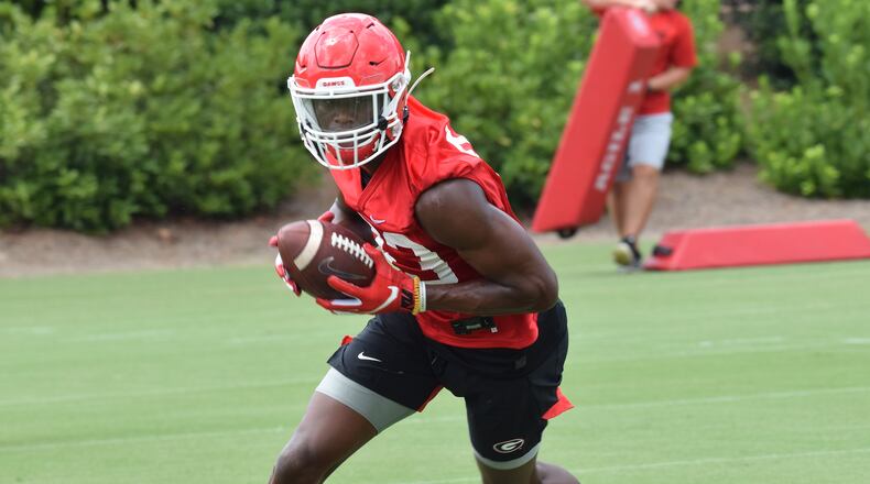 Georgia receiver George PIckens (83) hauls in a pass during one of the Bulldogs' early practices of the preseason. The 5-star signee from Hoover will wear the No. 1 during games this year.