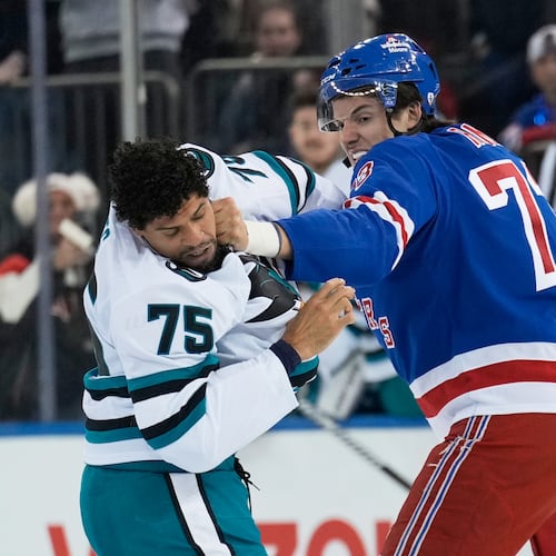 FILE - New York Rangers' Matt Rempe, right, fights with San Jose Sharks' Ryan Reaves (75) during the first period of an NHL hockey game in New York, Oct. 23, 2025. (AP Photo/Seth Wenig, File)