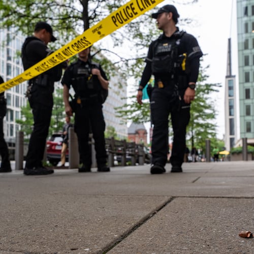 U.S. Secret Service Police officers place crime scene tape after a copper jacket of a bullet was found near the scene of a shooting close to the White House, Sunday, May 24, 2026, in Washington. (AP Photo/Alex Brandon)