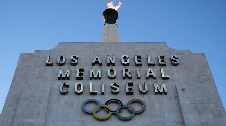 The Olympic cauldron is lit at the Los Angeles Memorial Coliseum ahead of the launch for ticket registration to the 2028 Summer Olympic Games Tuesday, Jan. 13, 2026, in Los Angeles. (AP Photo/Damian Dovarganes)