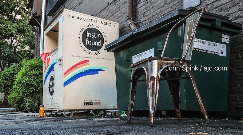 The woman was discovered with her head stuck in a metal clothing donation bin outside Henry’s Midtown Tavern on 10th Street.