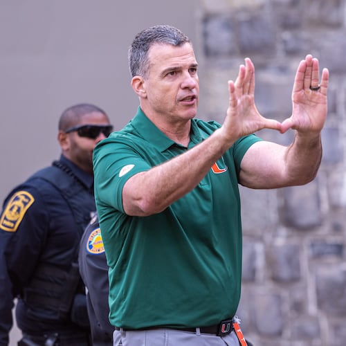 Miami head coach Mario Cristobal gestures towards the fans after defeating Virginia Tech in an NCAA college football game, Saturday, Nov. 22, 2025, in Blacksburg, Va. (AP Photo/Robert Simmons)