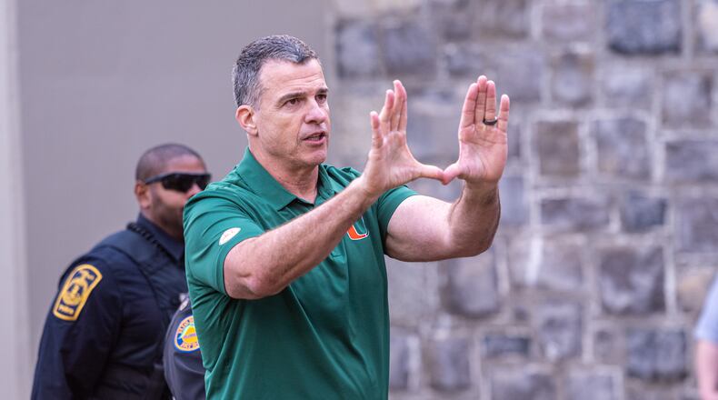 Miami head coach Mario Cristobal gestures towards the fans after defeating Virginia Tech in an NCAA college football game, Saturday, Nov. 22, 2025, in Blacksburg, Va. (AP Photo/Robert Simmons)