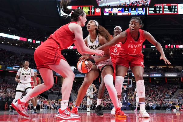 Indiana Fever guard Caitlin Clark, left, fouls Chicago Sky forward Angel Reese, center, during the second half an WNBA basketball game in Indianapolis, Saturday, May 17, 2025. (AP Photo/AJ Mast)