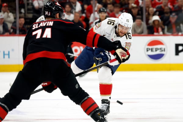 Florida Panthers' Aleksander Barkov (16) clears the puck past Carolina Hurricanes' Jaccob Slavin (74) during the first period of Game 5 of the NHL hockey Stanley Cup Eastern Conference finals in Raleigh, N.C., Wednesday, May 28, 2025. (AP Photo/Karl DeBlaker)