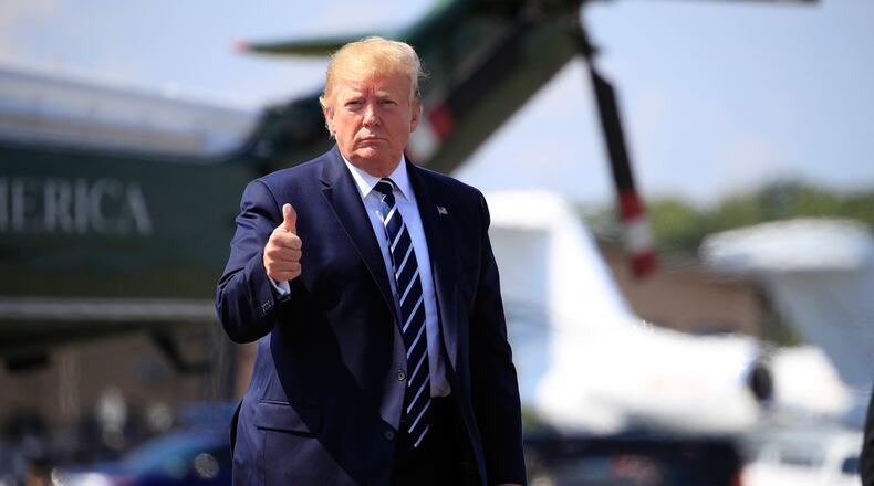 President Donald Trump gives a thumbs-up as he walks on the tarmac to board Air Force One at Morristown Municipal Airport, in Morristown, N.J., on his way returning back to the White House Sunday, July 21, 2019.