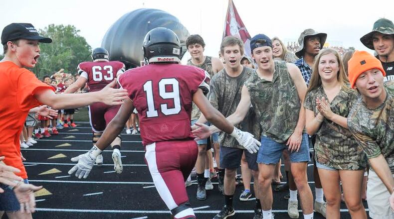 Alpharetta sophomore safety Vinny Dugassani enters the field to play West Forysth as fans cheer before a high school football game in Alpharetta, Friday, Sept., 4, 2015. (Photo/John Amis)