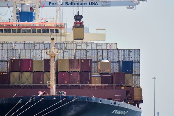 A crane lifts a container from the cargo ship Epaminondas at the Port of Baltimore, Wednesday, April 9, 2025, in Baltimore. (AP Photo/Stephanie Scarbrough)