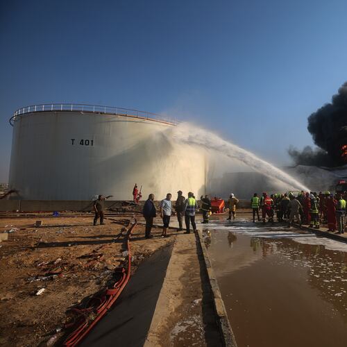 Firefighters work to contain a fire at the Zawiya oil refinery following a drone strike in Zawiya, Libya, Tuesday, Aug. 11, 2026. (AP Photo/Yousef Murad)