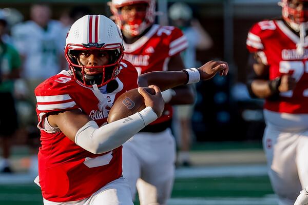 Gainesville quarterback Kharim Hughley rushes against Buford during their game on Saturday, Aug. 22, 2026, in Buford. (Erik S. Lesser for the AJC)