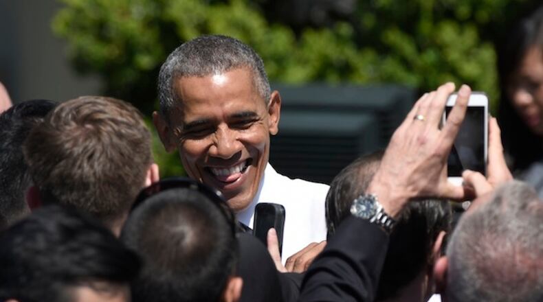 President Barack Obama greets guests on the South Lawn of the White House in Washington, Thursday, April 14, 2016, during a ceremony for the start of the Wounded Warrior Ride. The ride is to raise awareness of our nation's heroes who battle the physical and psychological damages of war. (AP Photo/Susan Walsh)