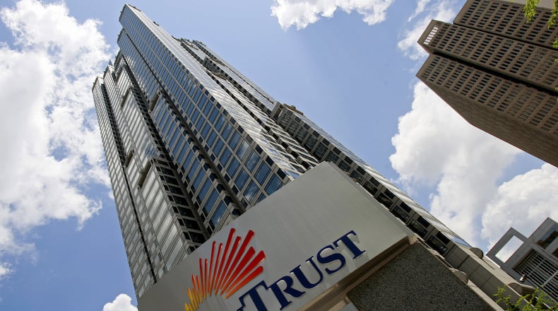 Profits at Georgia’s banks rose almost 5 percent last year despite a late-year dip in income at the state’s biggest bank, SunTrust. (AP Photo/John Bazemore)