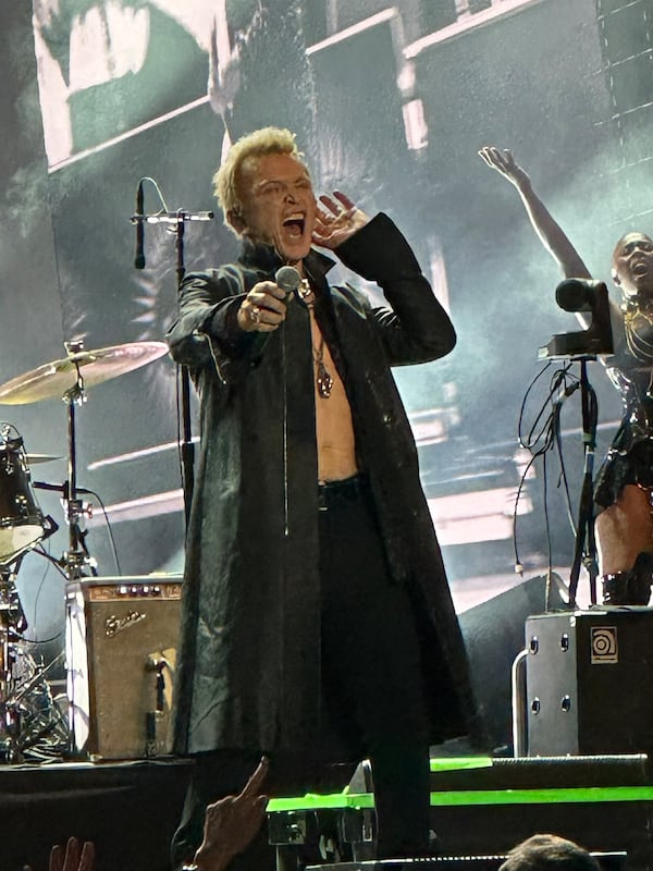 Billy Idol playfully gives the crowd a chance to do callbacks during his nearly sold-out concert at Ameris Bank Amphitheatre on Friday. (Rodney Ho/AJC)