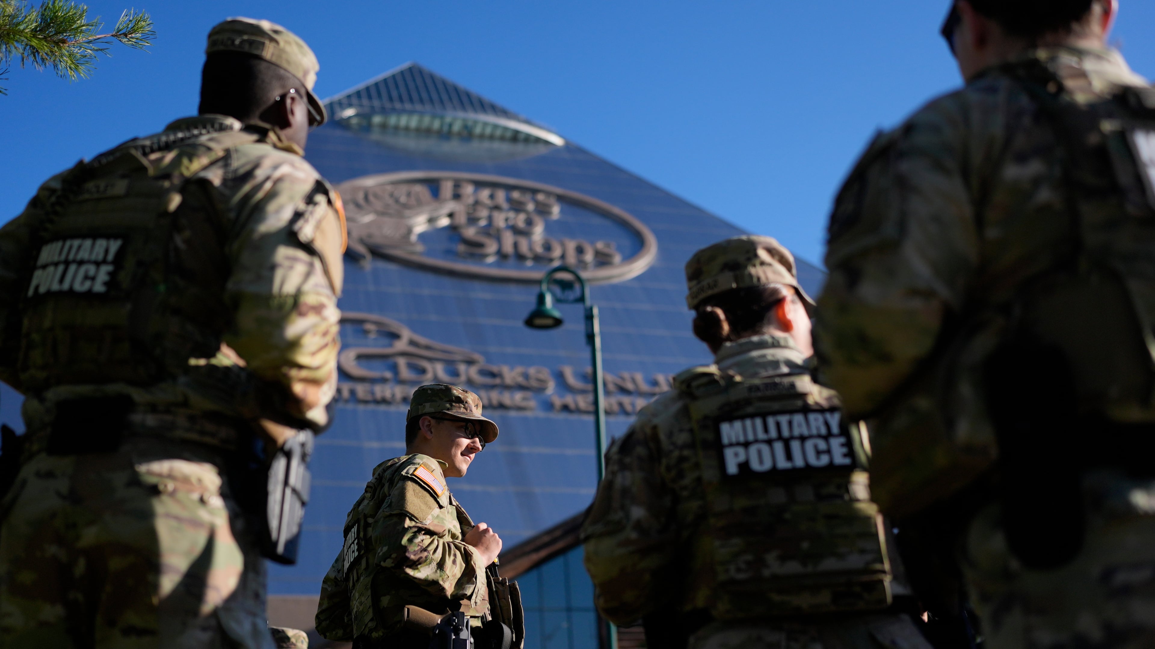 Members of National Guard patrol outside a Bass Pro Shops, Friday, Oct. 10, 2025, in Memphis, Tenn. (AP Photo/George Walker IV)