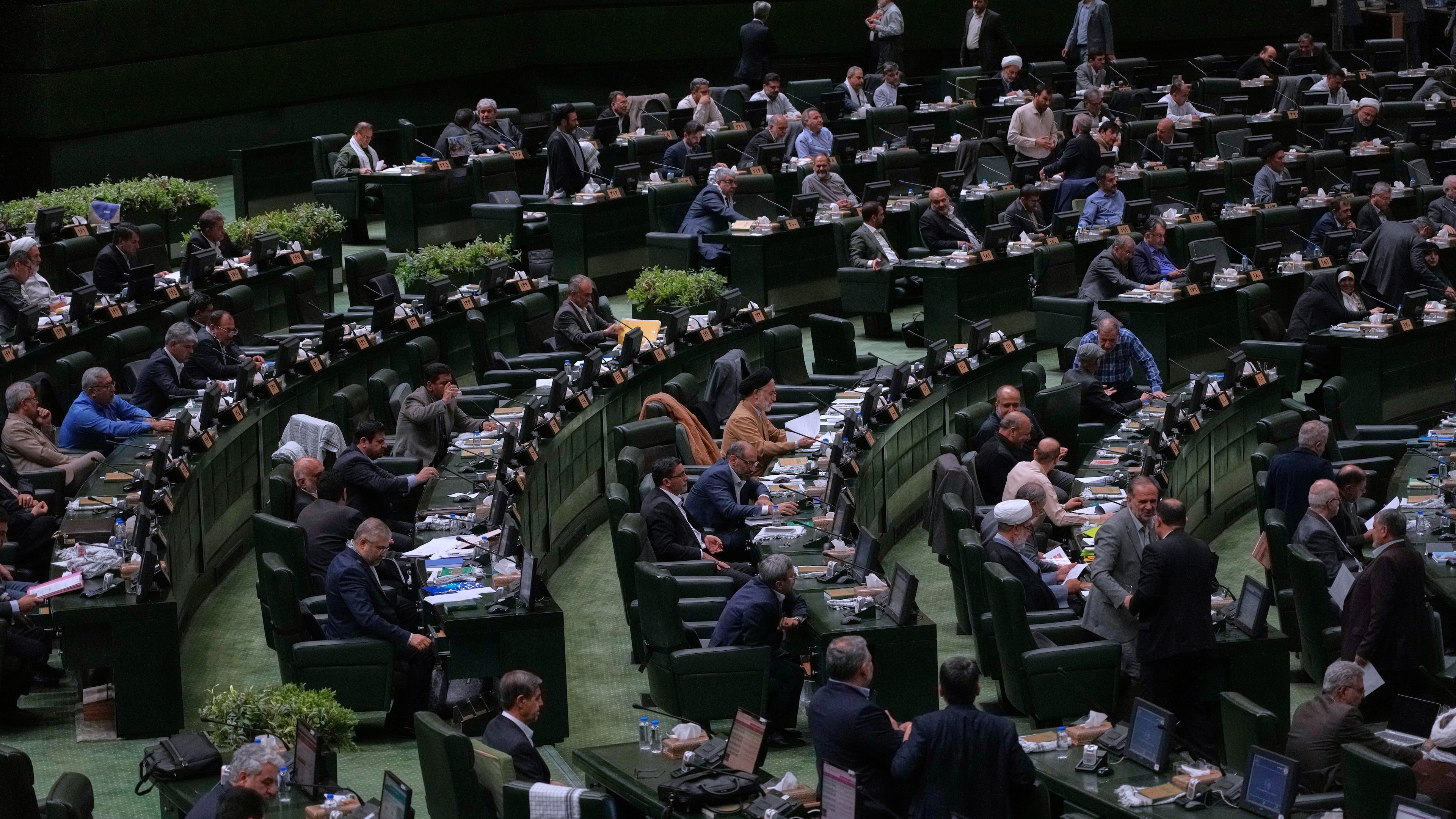 Iranian lawmakers attend an open session of parliament in Tehran, Iran, Sunday, Sept. 28, 2025. (AP Photo/Vahid Salemi)