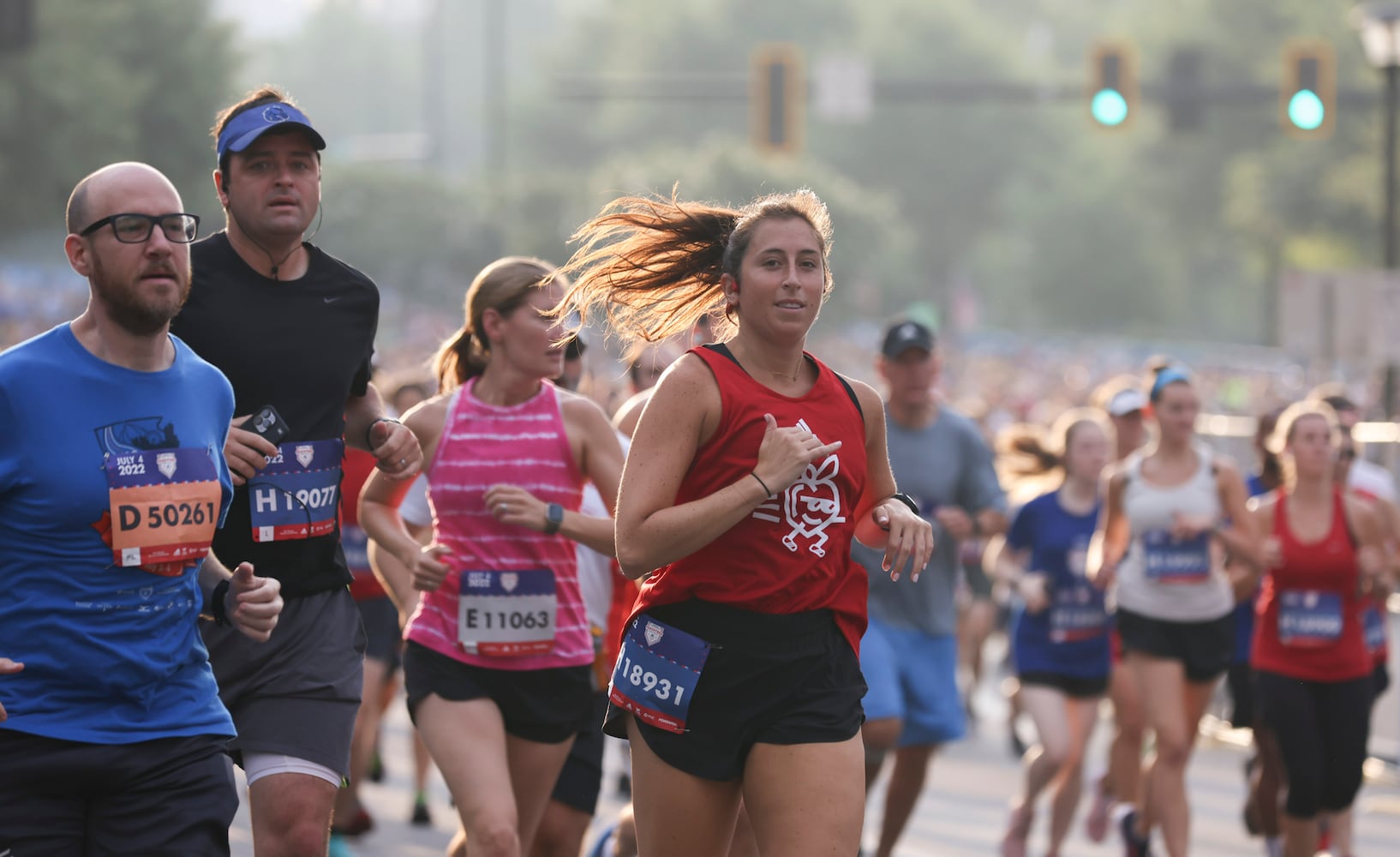 Runners take off at the start of the 53rd running of the Atlanta Journal-Constitution Peachtree Road Race in Atlanta on Monday, July 4, 2022. (Jason Getz / Jason.Getz@ajc.com)