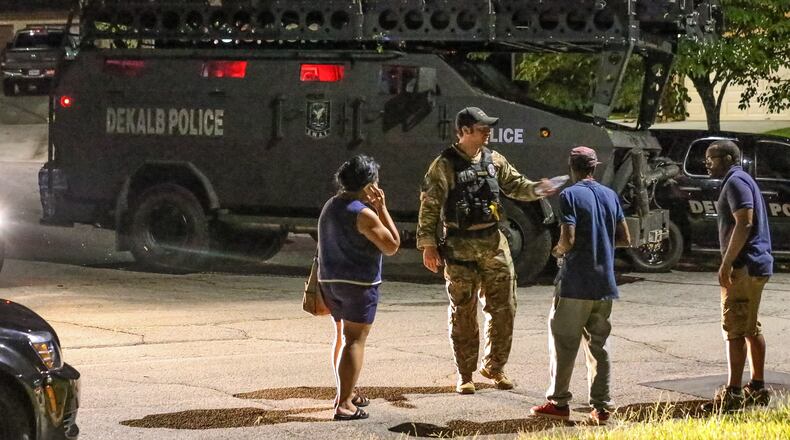 Officers were searching a home Wednesday when a man wanted on a burglary charge pointed a gun at them, according to Channel 2 Action News. SWAT was called in to assist. JOHN SPINK / JSPINK@AJC.COM