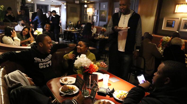 People attend Ludacris’ late night party at the Hotel Clermont in Atlanta early Friday morning. Chicken+Beer food was served to the guests. EMILY HANEY / EMILY.HANEY@AJC.COM