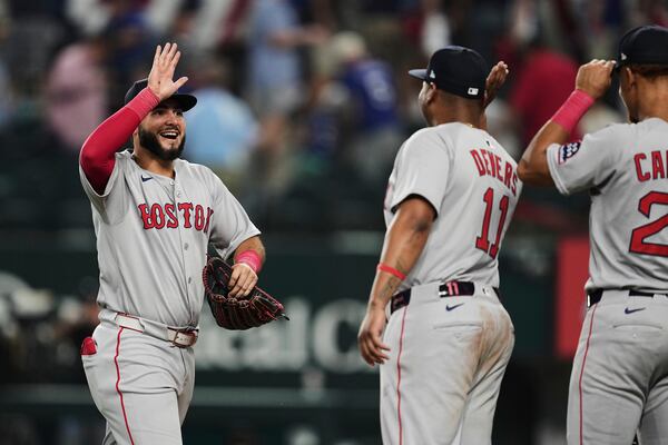 Boston Red Sox's Wilyer Abreu, left, celebrates with Rafael Devers (11) after the team's win against th Texas Rangers in an opening-day baseball game, Thursday, March 27, 2025, in Arlington, Texas. (AP Photo/Tony Gutierrez)