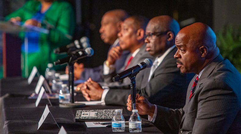 Clayton County sheriff candidates (from left) Clarence Cox, Terry Evans, Dwayne Fabian and Chris Storey gather to debate Tuesday at Tabernacle of Praise Church International in Jonesboro. (Jenni Girtman for Atlanta Journal-Constitution)