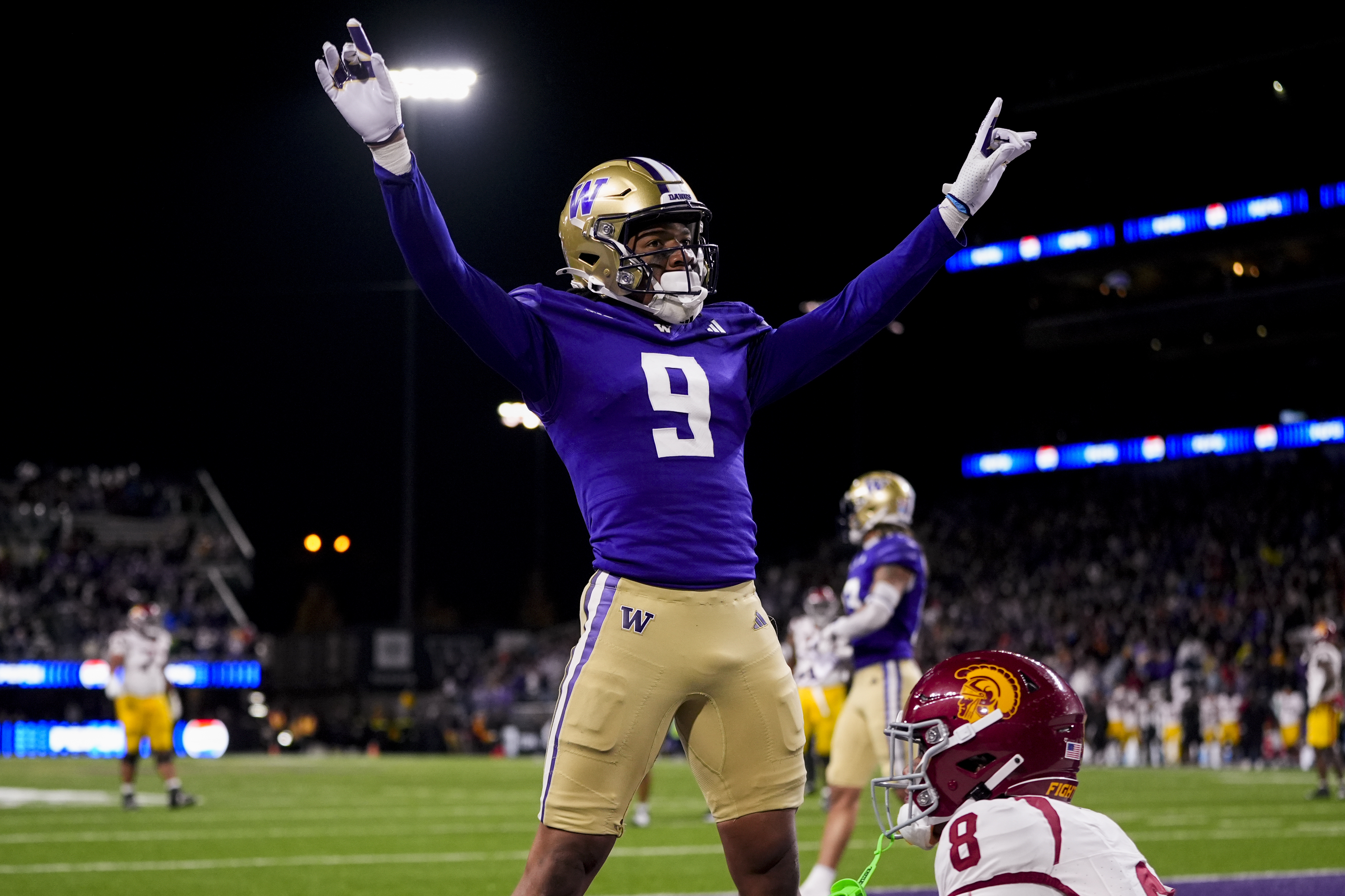 Washington cornerback Thaddeus Dixon celebrates after breaking up a pass to USC wide receiver Ja’Kobi Lane (lower right) during the 2024 season. (Lindsey Wasson/AP)