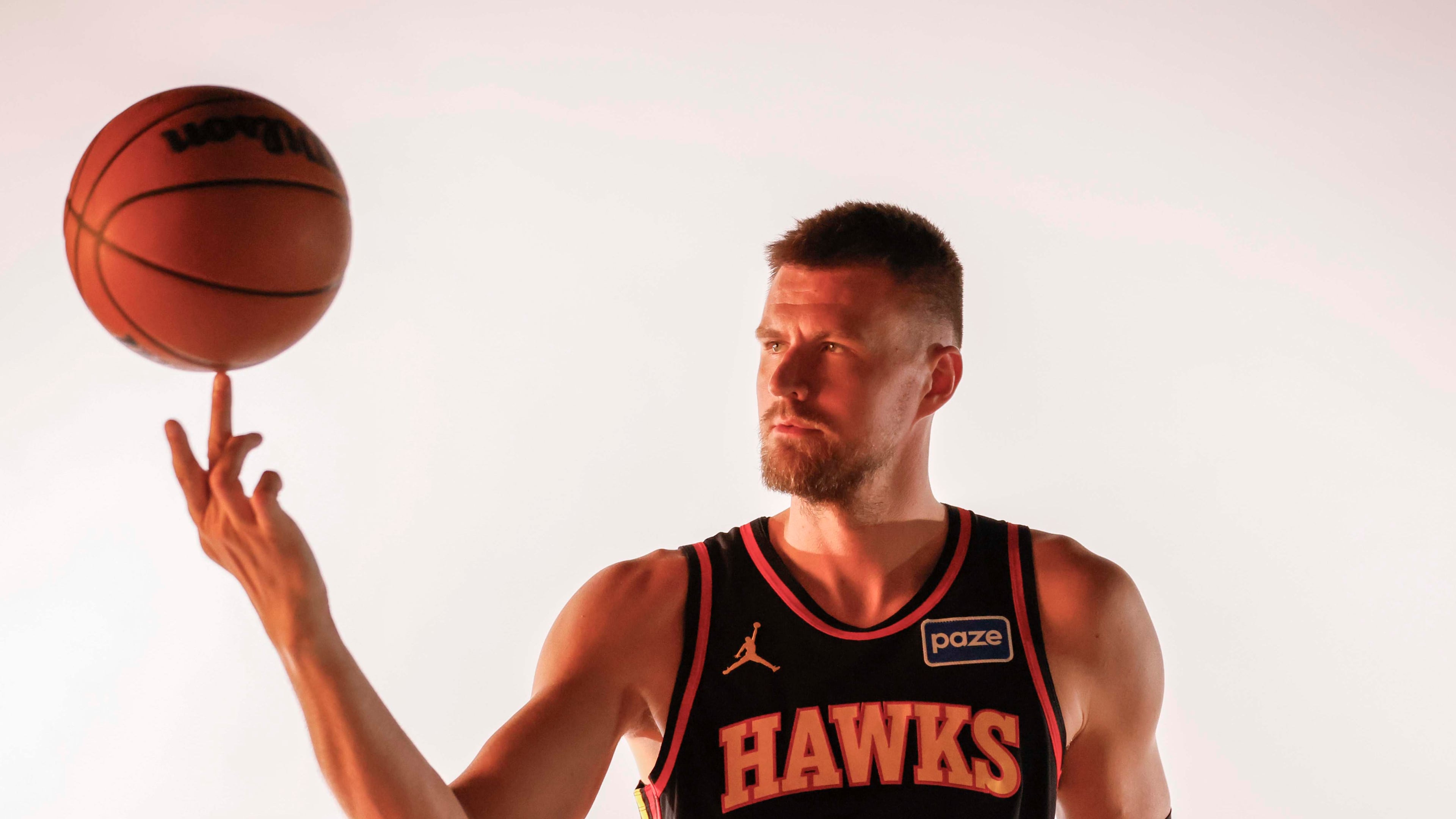 Atlanta Hawks center Kristaps Porzingis spins the ball during media day at PC&E Atlanta, Sept. 29, 2025. (Miguel Martinez/AJC)