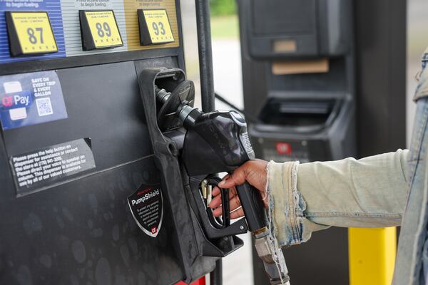 Lala Long returns a gas pump at a QuikTrip in Mableton on May 6, 2026. Prices have soared above $4 per gallon as peak travel season approaches. (Arvin Temkar/AJC)