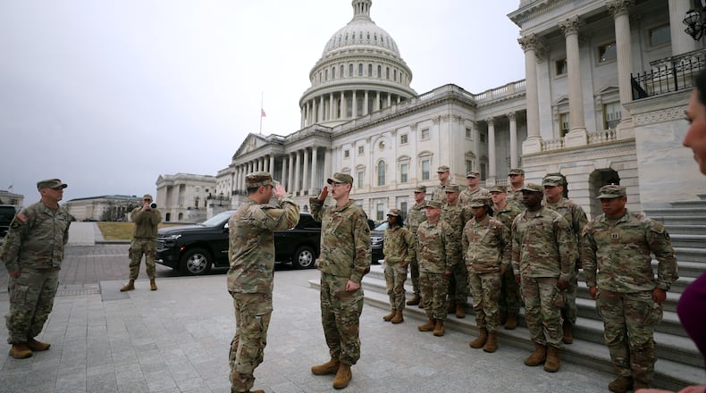 National Guard are seen on the East Front of the U.S. Capitol, Wednesday, Jan. 14, 2026, in Washington. (AP Photo/Rahmat Gul)
