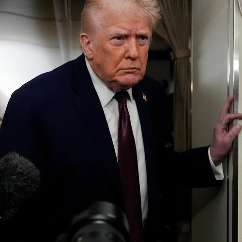 President Donald Trump speaks to reporters while in flight on Air Force One to Joint Base Andrews, Md., Sunday, Jan. 11, 2026. (AP Photo/Julia Demaree Nikhinson)