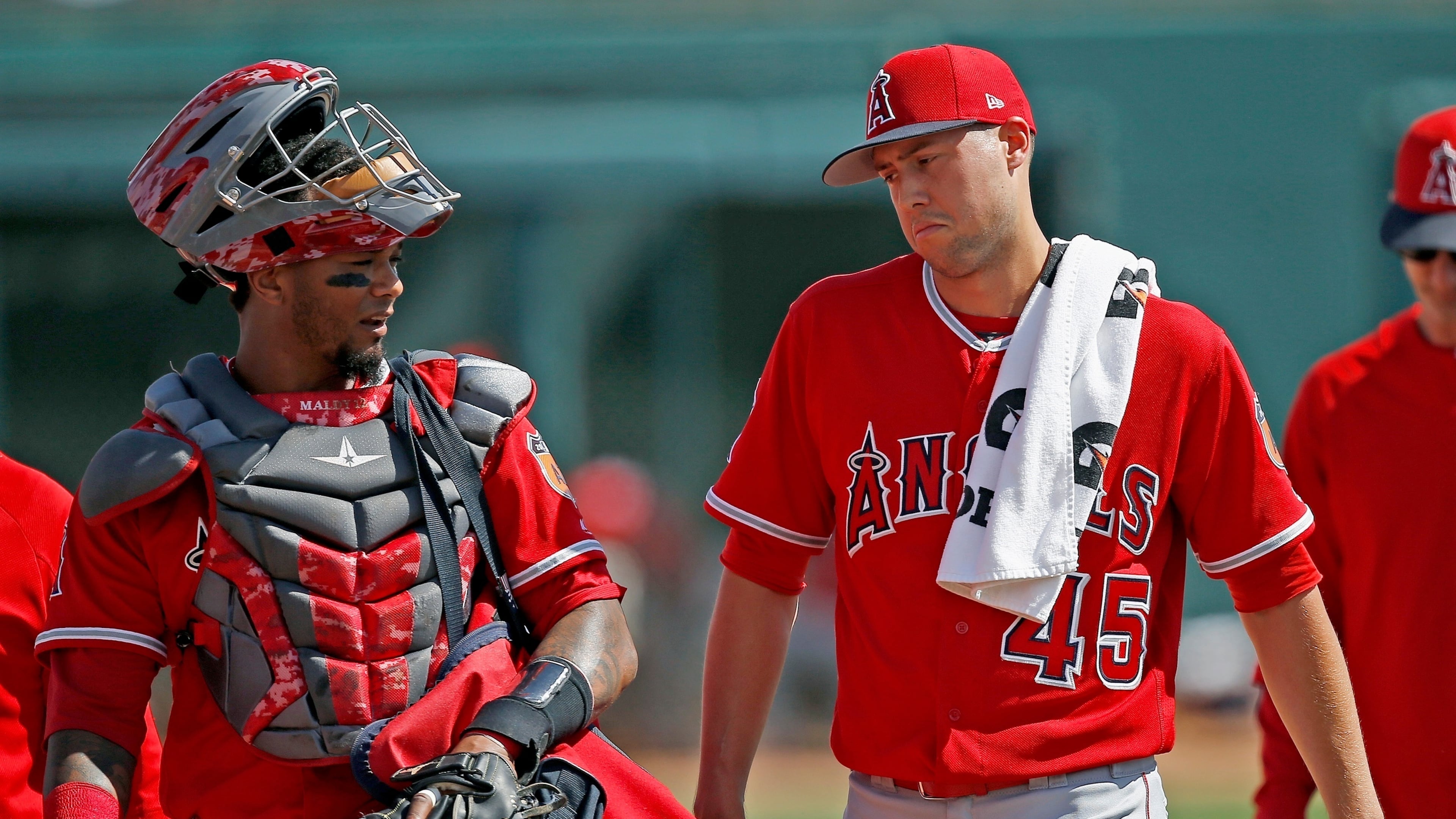 FILE - Los Angeles Angels starting pitcher Tyler Skaggs (45) talks with catcher Martin Maldonado, left, after warming up in the bullpen prior to a spring training baseball game against the Chicago White Sox, March 4, 2017, in Glendale, Ariz. (AP Photo/Ross D. Franklin, File)