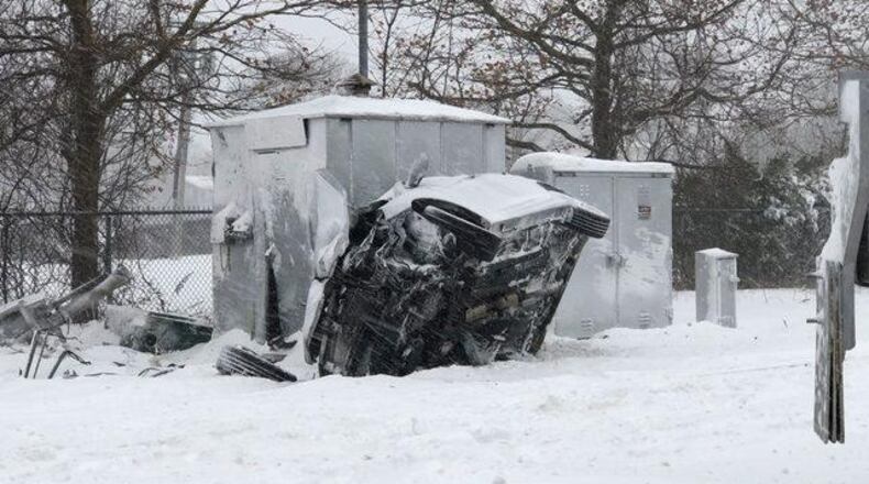 The car was covered in snow and was hit by a train after being stuck on  railroad tracks in Massachusetts.