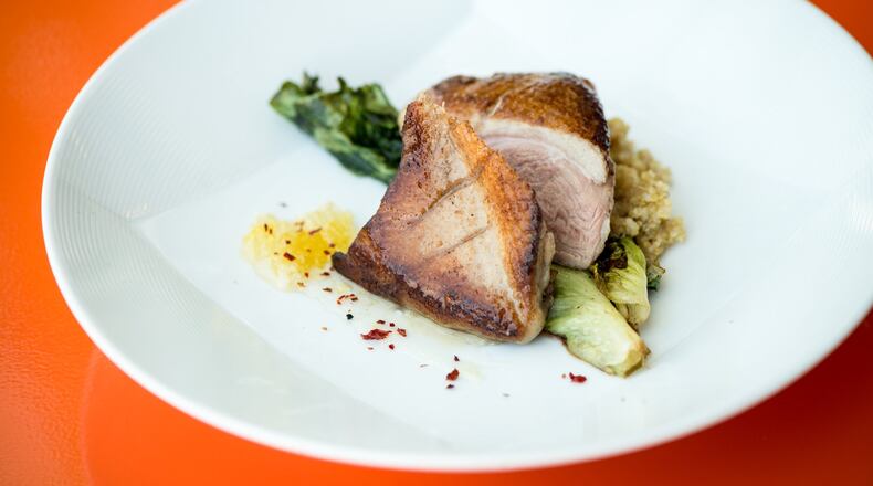 Expat Fowl entree, duck with grilled escarole, Calabrian chili honey, and quinoa. Photo credit- Mia Yakel.