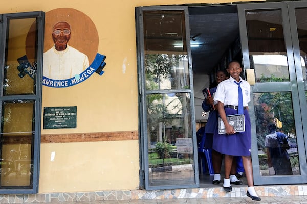 Students walk out of the dining hall at Uganda Martyrs' Secondary School Namugongo, in Kampala, Uganda Monday, May 26, 2025. (AP Photo/Hajarah Nalwadda)
