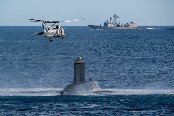 FILE - A Turkish navy helicopter, ship and submarine take part in a warfare exercise off the coast of Catania, Sicily, southern Italy, Monday, Feb. 26, 2024. (AP Photo/Salvatore Cavalli, File)