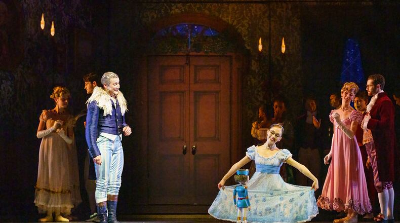 Drosselmeier (Jacob Bush) looks on as Marie (Kaitlin Roemer) dances with her Nutcracker.